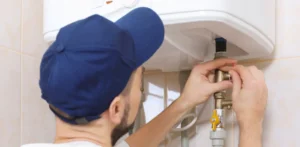 worker doing a water heater installation